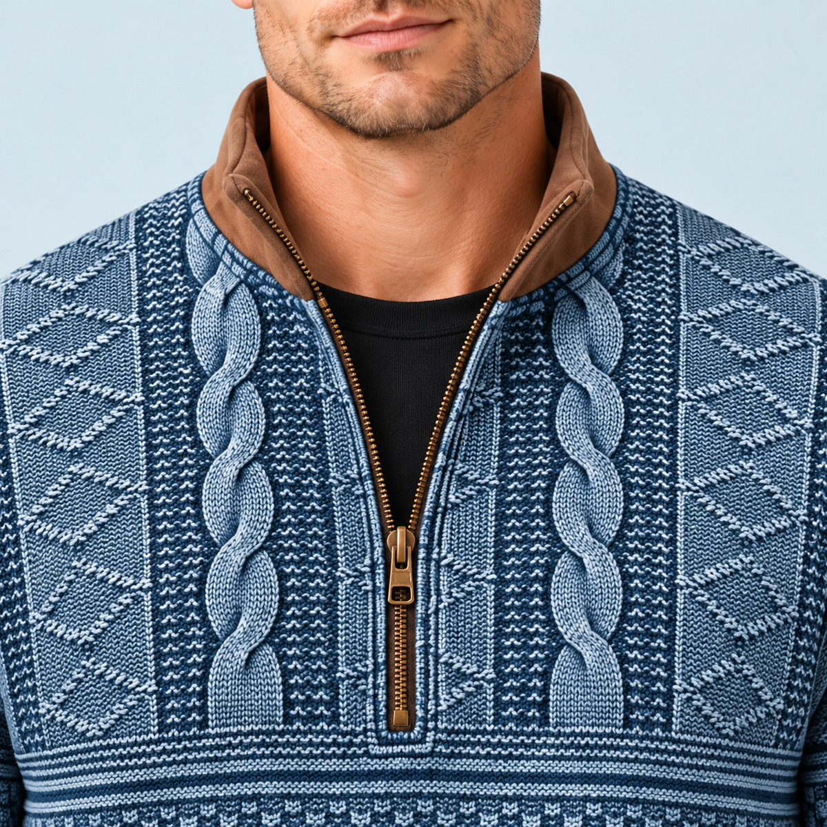 Détail du col contrasté, de la fermeture zippée et des motifs du pull bleu